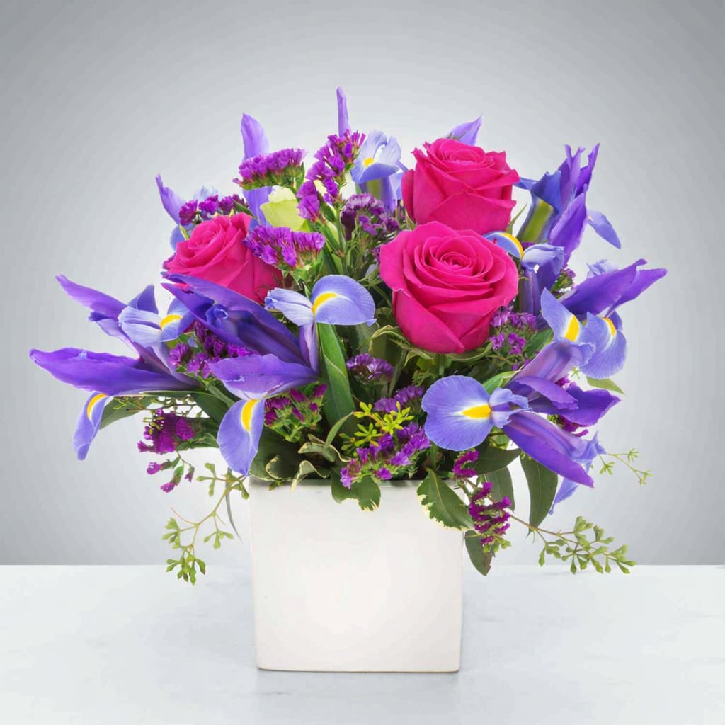 Sapphire Summer  - Pink rose roses and vivid blue iris make this arrangement pop! Sapphire Summer makes a great gift for September birthdays, welcoming a new baby boy, or just spreading some joy.  Due to the current situation, supply is limited, therefore, color and variety substitutions may be necessary, please specify if you have a preferred color and we will do our best to accommodate your request.