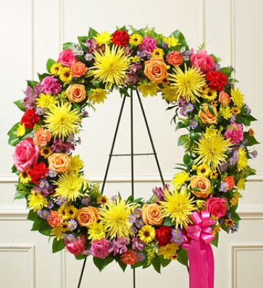 Serene Blessings Bright Standing Wreath - During times of sorrow and loss, a beautiful expression of your sympathies can help convey your comfort and support to family and friends. This lovely standing wreath, crafted by our expert florists using a gathering of fresh, colorful flowers, helps let them know that brighter days are ahead. Note: Image shown is Premium.