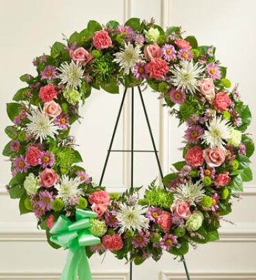 Serene Blessings Pastel Standing Wreath - A beautiful life deserves to be remembered in an equally beautiful way. Crafted by our expert florists from long-stem pink roses, mums, carnations and more in soft pastel shades, this exquisite standing wreath is a tasteful and elegant arrangement that reflects all of the love and sympathy in your heart.  Standing wreath arrangement of fresh long-stem pink roses arranged with mums, stock, carnations, heather, bottom poms, monte casino, salal and more. Note: Image shown is Premium.