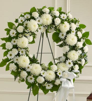 Serene Blessings White Standing Wreath - Sometimes, finding the words to show how much a loved one will be missed can be very hard. When you select this standing wreath of all-white flowers, expertly designed and crafted by one of our local florists, you're sending an arrangement that reflects all of the respect, love and compassion you want to express during this difficult time. Note: Image shown is Premium.