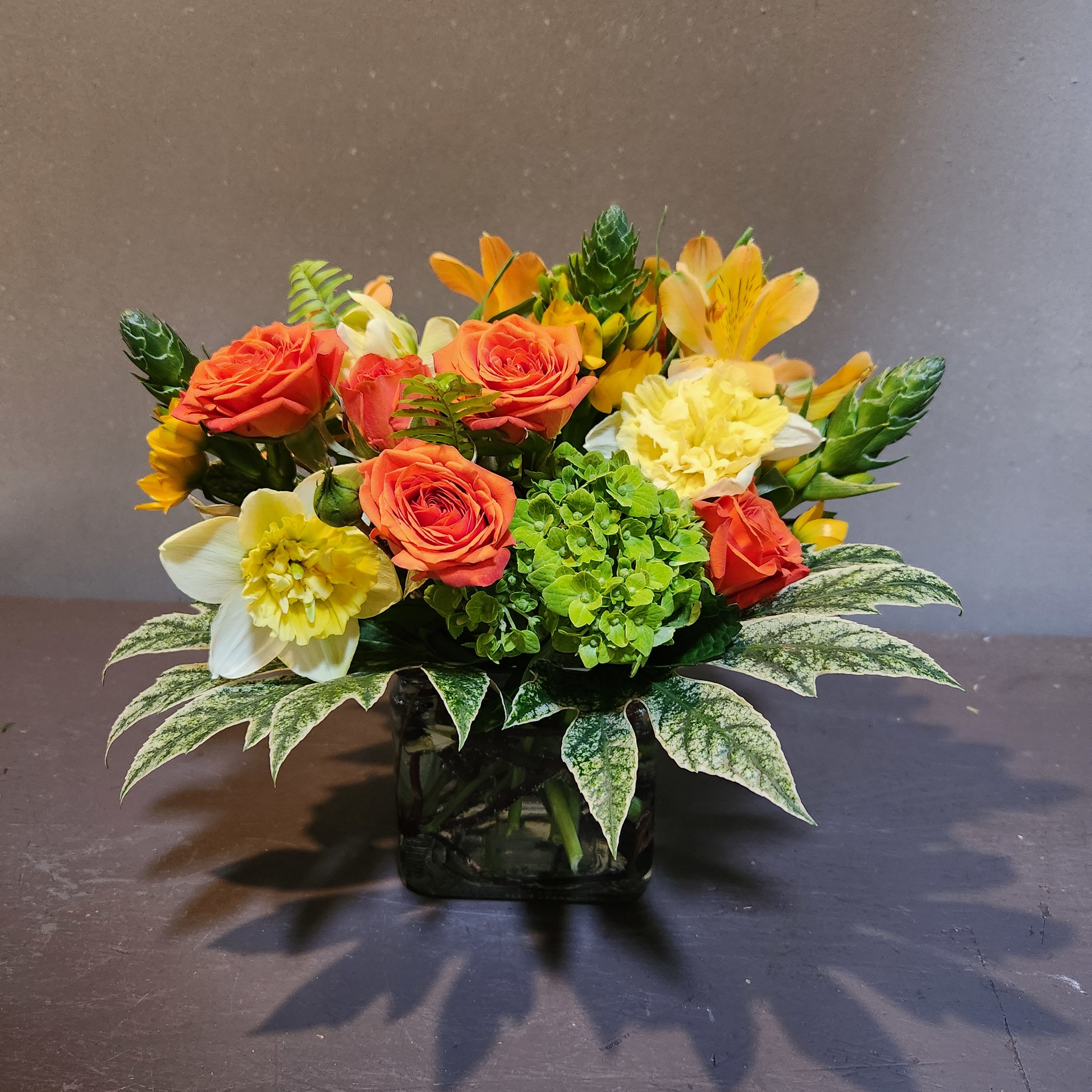 A Little Pop of Sunshine - A bright pop of fresh flowers to brighten your day.  Measures approx. 10"T x 12"W and arrives in a clear cube vase.