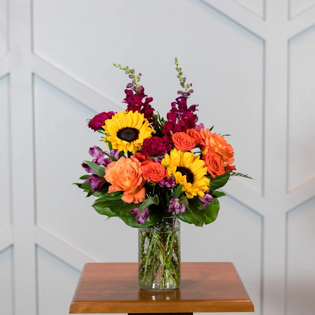 Amethyst - Bright yellow, purple, and orange make for a vibrant arrangement that is sure to please any person who loves bright colors.  Approximate Dimensions: 18"H X 10"W 