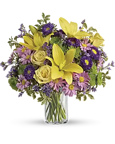 Fresh and Fabulous - Golden roses and lilies, lavender blooms and bright greens are a recipe for fresh, fabulous greetings! Turn any day into a special one with this happy surprise, arranged in a classic glass cylinder.