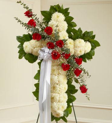 Peace and Prayers Standing Cross - Red - This standing spray arrangement in the shape of a cross is created from fresh white mums, red roses, spiral eucalyptus and more. This beautiful floral tribute shows your faith, hope and love during this difficult time. Note: Image shown is Premium.