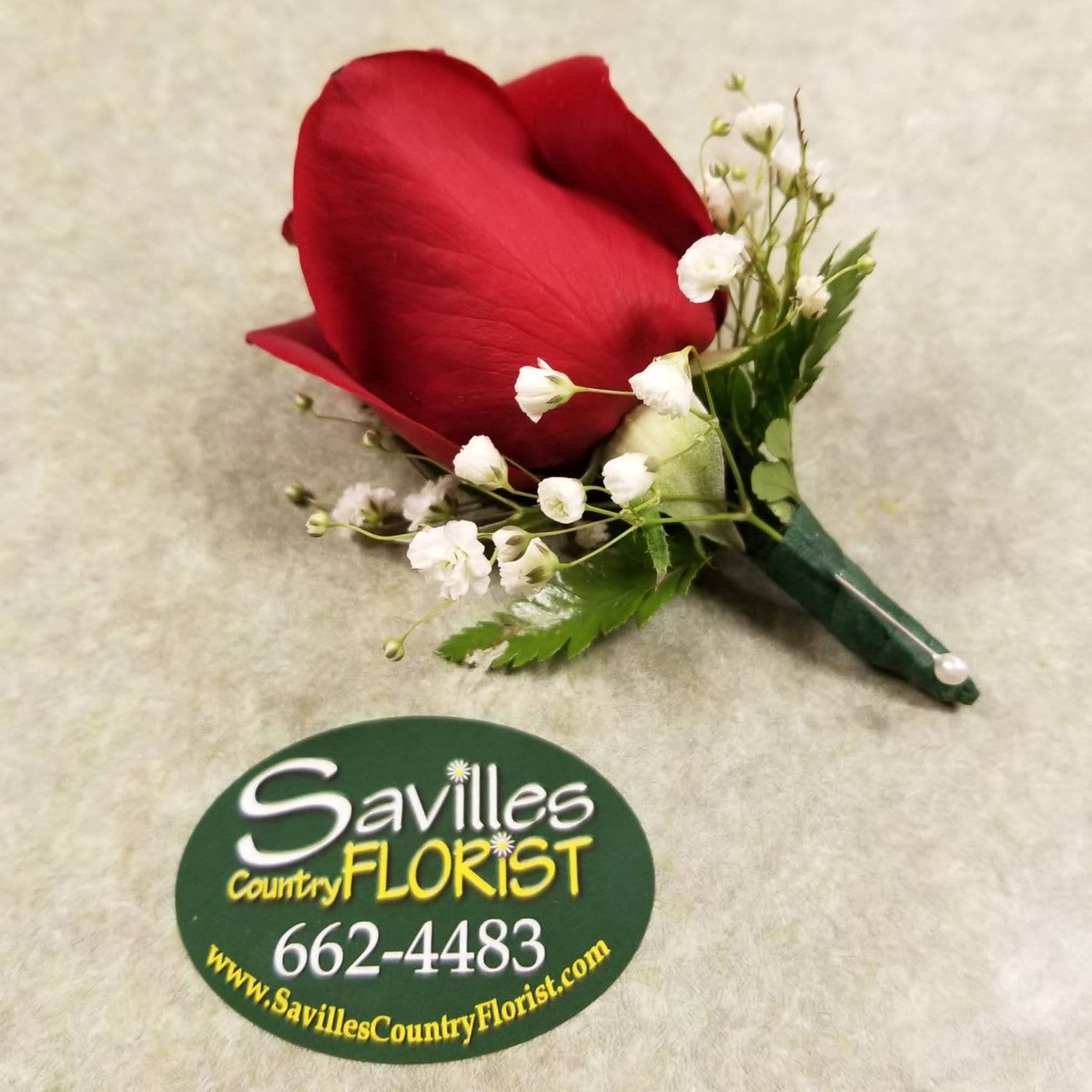 Red rose boutonniere with white baby's breath and green ribbon
