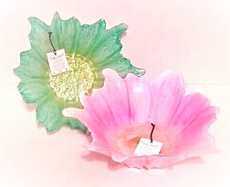 Two decorative glass flower-shaped bowls, one green and one pink