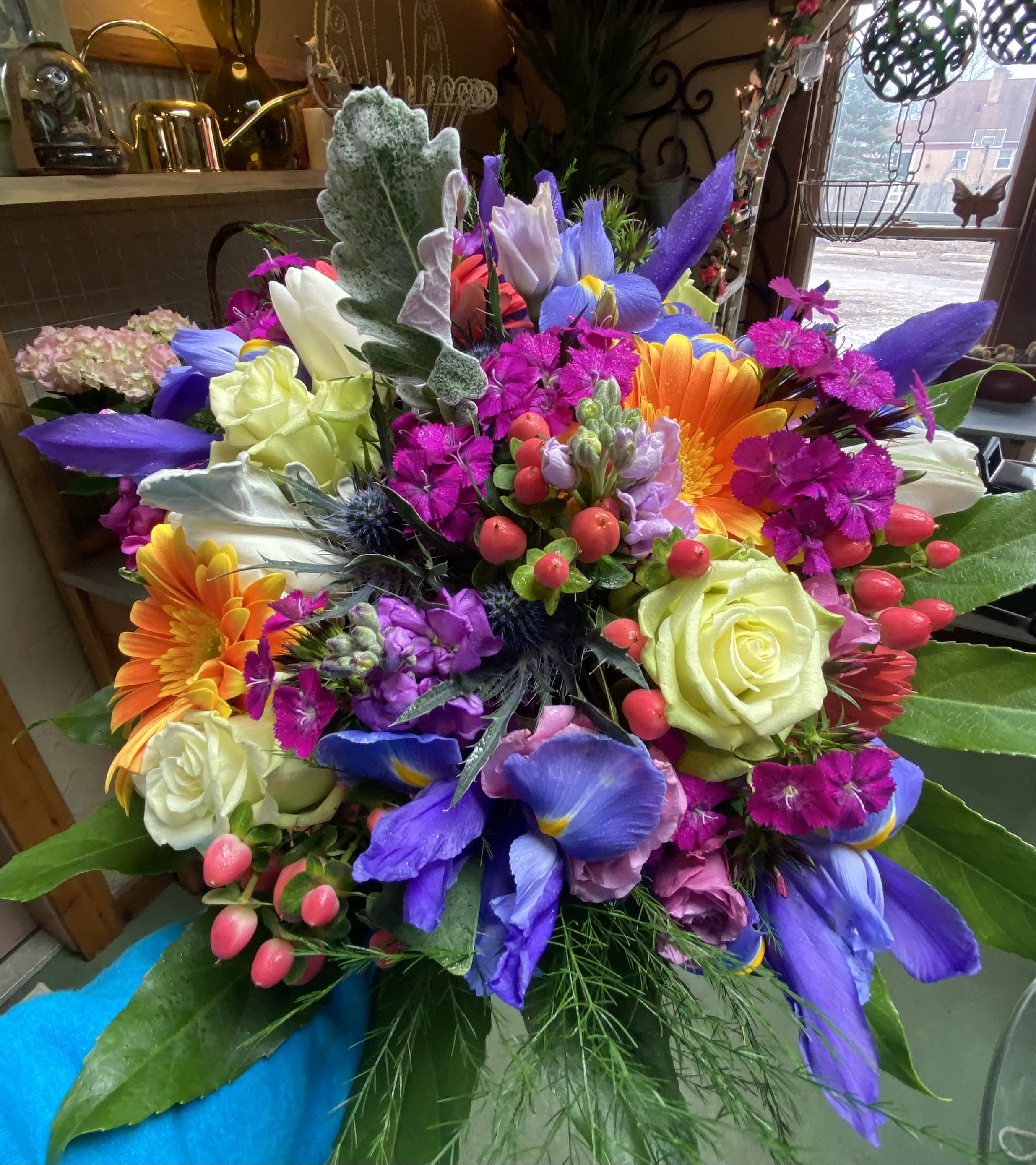 Colorful mixed bouquet with roses, gerbera daisies, and purple irises