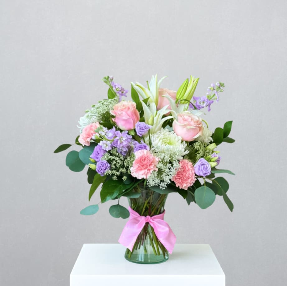Garden of Gratitude - MOTHER'S DAY COLLECTION | LOCAL DELIVERY ONLY  A lush expression of appreciation, "Garden of Gratitude" is designed in a clear gathering vase and is overflowing with pastel tones of pink, lavender, and white. Featuring roses, stock, hydrangea, mums, lilies, lisianthus, carnations, and touches of baby's breath. This garden-style arrangement brings softness and beauty to any space. a heartfelt gesture for a mom to celebrate. 