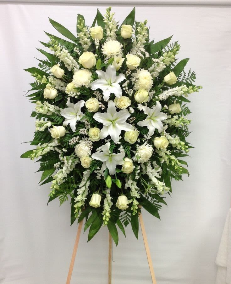 Celestial Peace Standing Arrangement - This arrangement focuses on the heavenly white blooms standing watch at a service, with a sophisticated and classic palette.