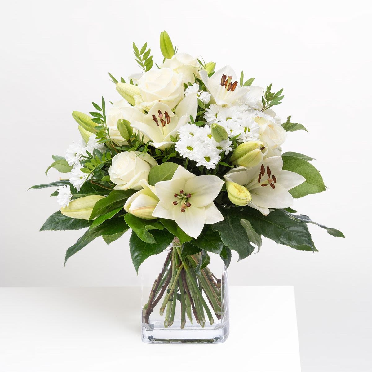Ivory Trumpets Arrangement - This arrangement is a peaceful and understated one, with a versatile and elegant array of flowers. 