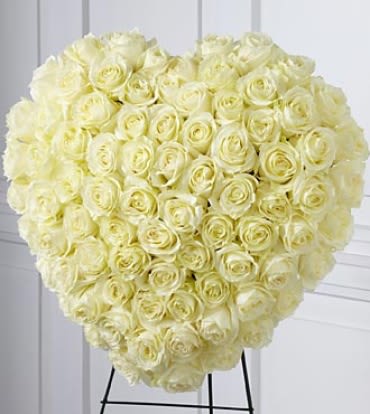The Elegant Remembrance Standing Heart - The Elegant Remembrance™ Standing Heart is an exquisite display of peace and love. 77 Stems of white roses are artfully arranged in the shape of a heart and presented on a wire easel, creating a simply beautiful tribute for their final farewell service. Approximately 24H x 22W. Note: Image shown is Premium.