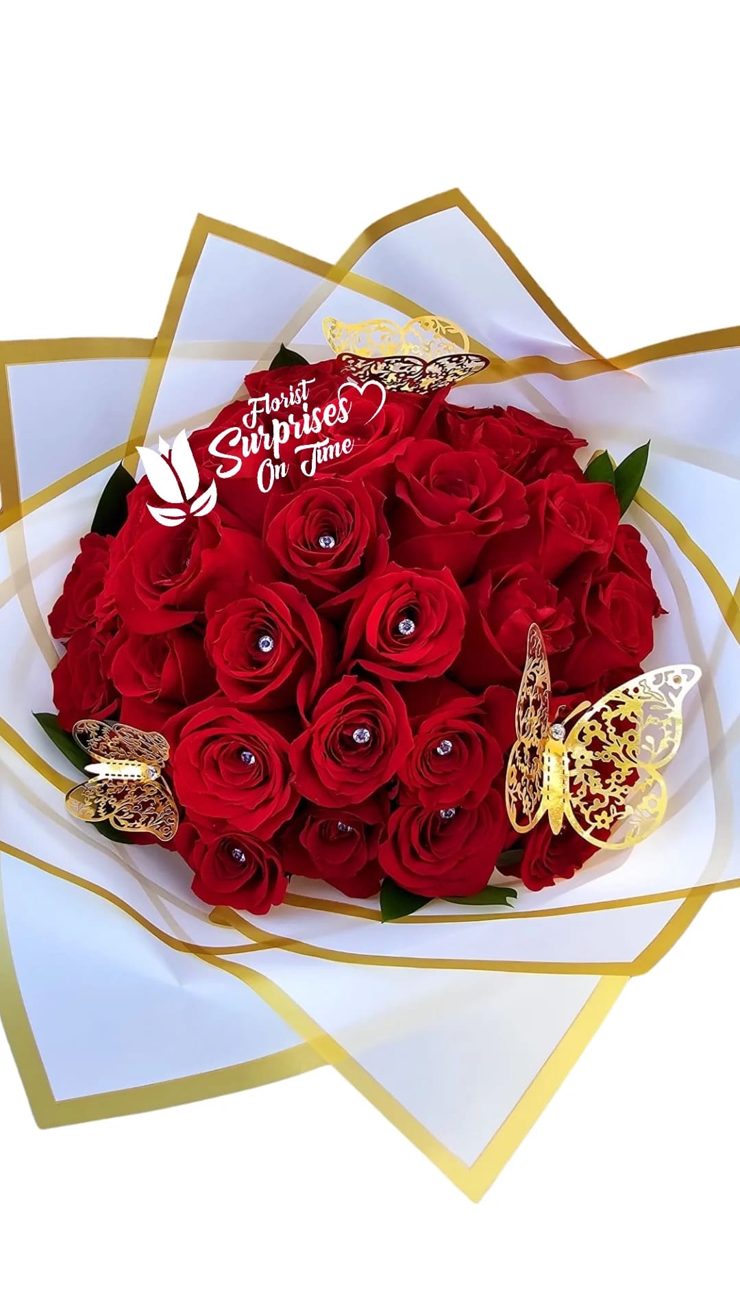Bouquet of red roses wrapped in white and gold paper with butterfly decorations