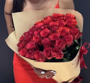 Red Roses Bouquet - 25, 50 &amp; 100 Stems - A stunning arrangement of fresh, premium red roses, carefully selected for their rich color, long stems, and flawless beauty. Designed in a refined European style, this bouquet represents elegance, romance, and timeless luxury. Each bouquet is handcrafted with attention to detail and finished with elegant wrapping and ribbon, making it perfect for anniversaries, romantic gestures, or unforgettable surprises. Choose your preferred size to match the moment — from a classic expression of love to a bold, luxurious statement. The bouquet size will increase based on your selection. The photo shows 25 roses (Standard size).