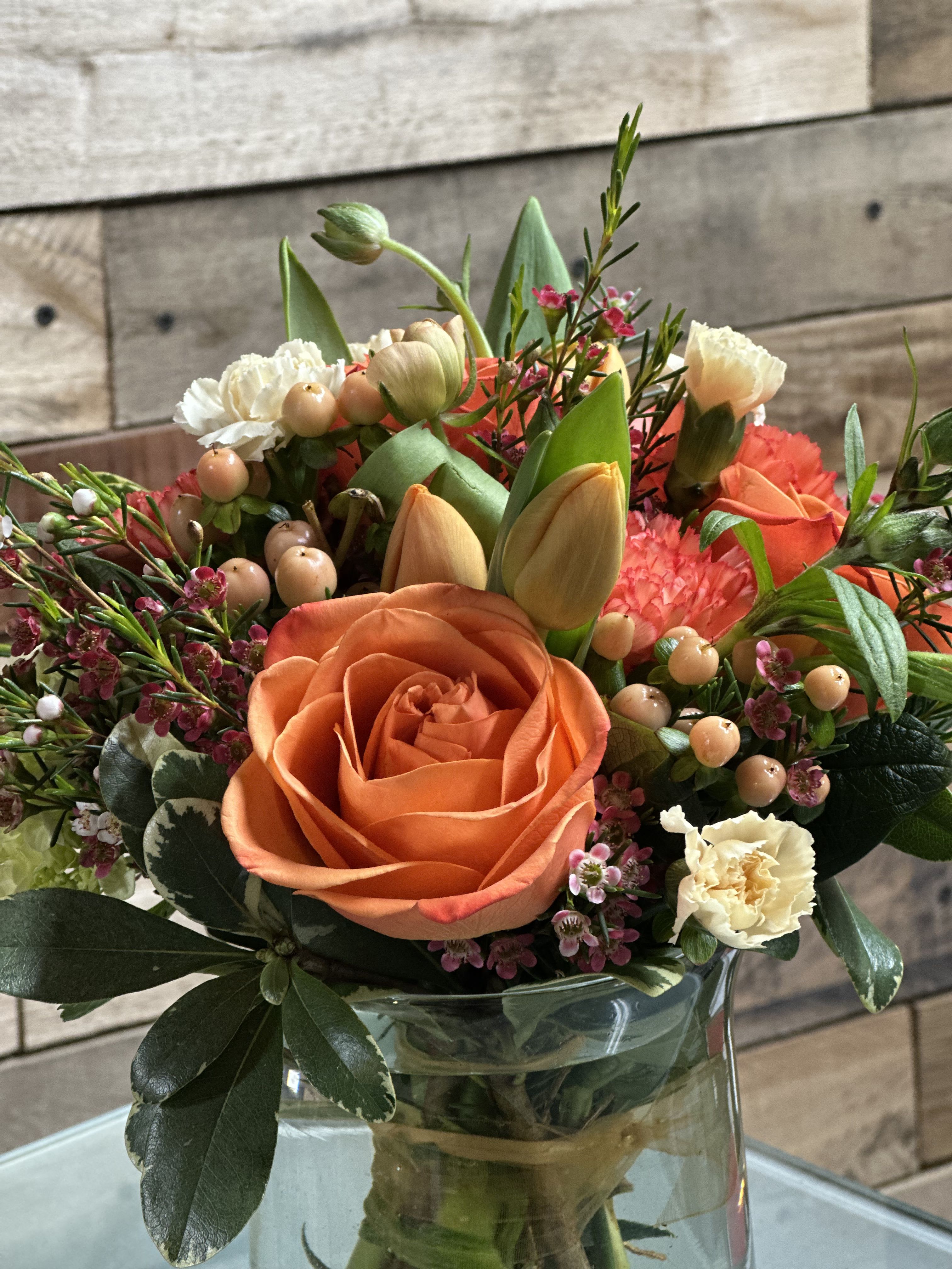 Petals &amp; Smiles - A vibrant orange rose takes center stage in this rounded flower arrangement, making Petals &amp; Smiles a cheerful everyday bouquet perfect for birthdays, thank-yous, or a just-because surprise. The warm mix of orange, pink, white, and green reads lively and affectionate-an arrangement that will make the person you're thinking of feel noticed and genuinely smiled at.