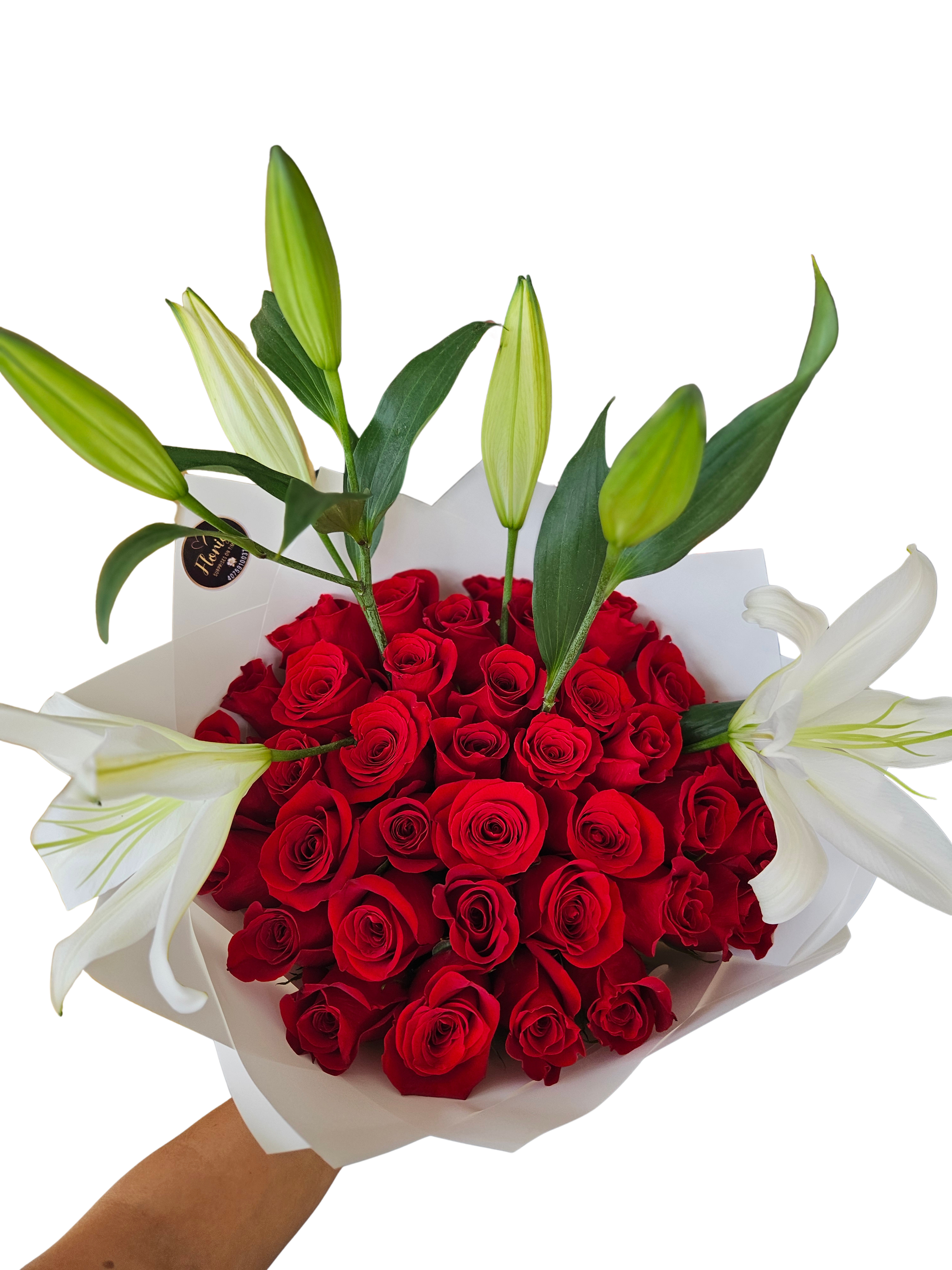 Bouquet of red roses with white lilies wrapped in white paper