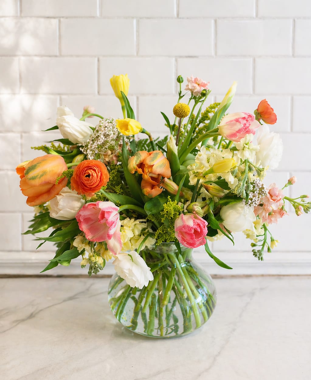 Sunshine Love - Celebrate spring with Sunshine Love, a bright and cheerful flower arrangement featuring beautiful tulips and garden roses. Designed to bring warmth, color, and elegance, this arrangement blends soft romantic blooms with vibrant seasonal tones for a fresh, uplifting look.  Perfect for Mother’s Day flowers, spring flower arrangements, birthdays, or everyday gifting, Sunshine Love is a beautiful choice for anyone looking to send flowers that feel joyful and full of life.  For Mother's Day, the color palette may shift toward romantic pink and peach tones.  *** Photo displayed is a deluxe ***