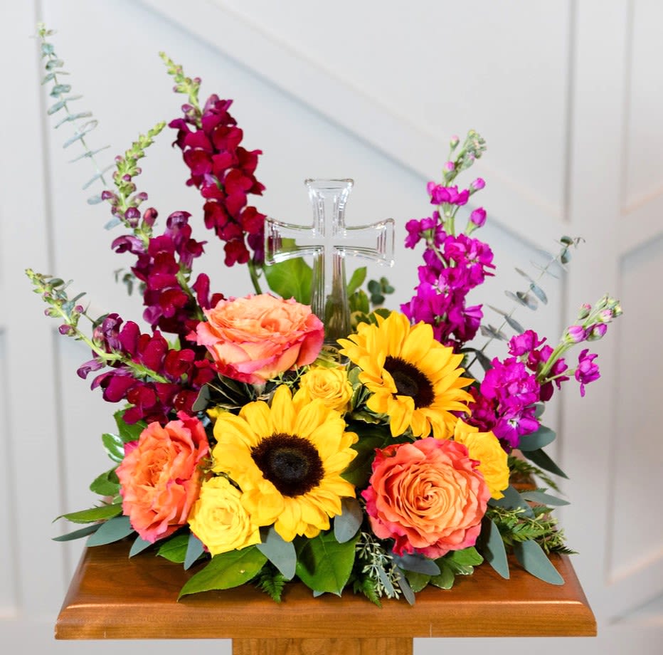 Vivid - A crystal cross surrounded by vibrant blooms is a reminder of caring thoughts.  Approximate Dimensions: 18" H X 16" W 