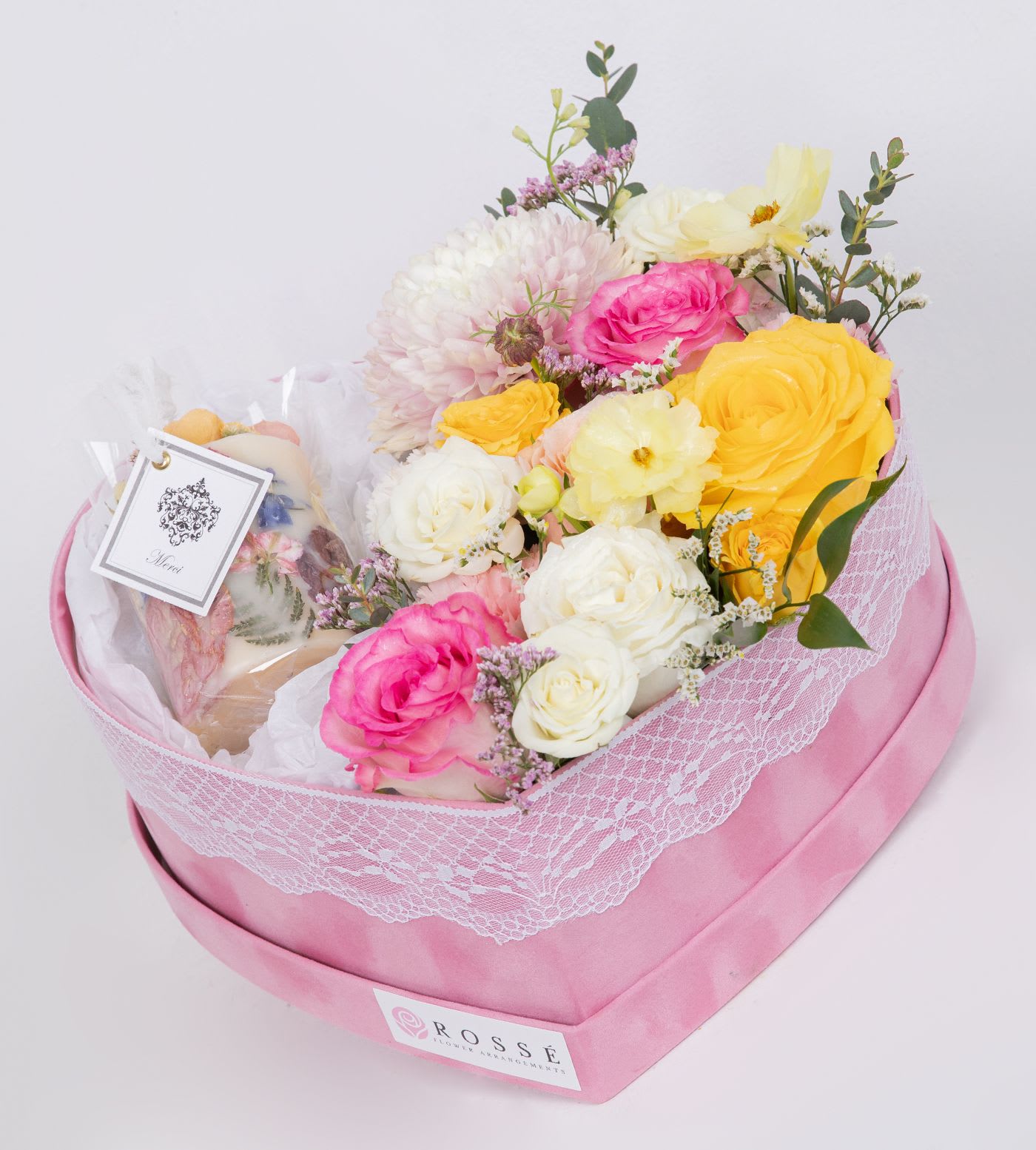 Sweet Heart Bloom with Dry Flower Candle - A romantic heart-shaped box filled with pastel roses and seasonal blooms, paired with a handcrafted dried flower candle. A perfect elegant gift for any special occasion. Handmade dry flower candle crafted with organic soy wax (Paraffin-free and made in the USA ) and infused with a soft, natural fragrance. Each piece features real fresh flowers, carefully dried and preserved to create a unique, artistic design Flower types may vary depending on the season.