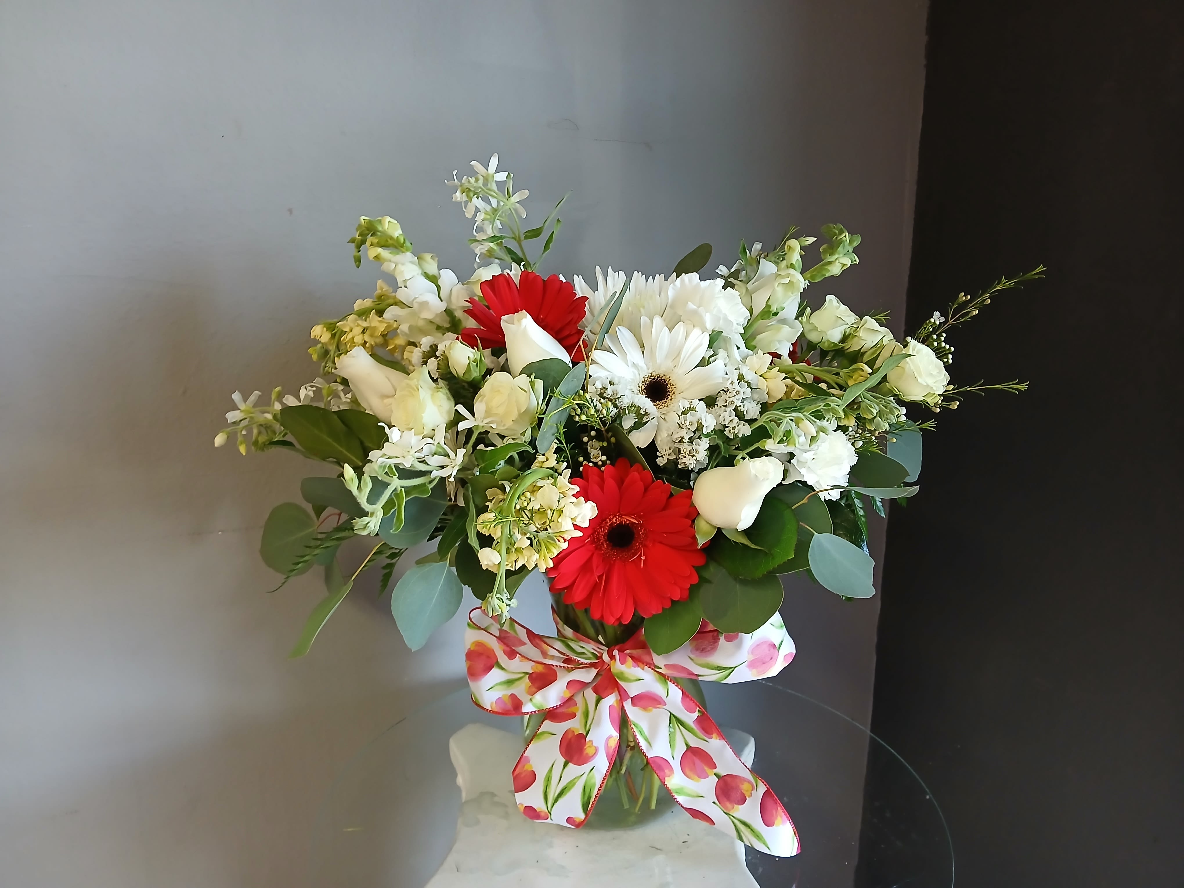 #712 Designer's Choice  - This beautiful flower arrangement of fresh mixed seasonal blooms is made by local designers in the heart Orange California. Hand crafted and perfect for every occasion, from birthdays and new babies to sympathy and just because. The best choice to show you are thinking of that special someone. Can be sent as a local delivery or in-store pickup. This is an original, one of a kind arrangement. Order now before it's too late!