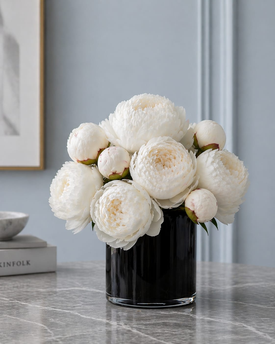 The Purest Peony - Lush + Luxe white peony artfully arrangement in a contrasting black glass vase low and lush.  This is the epitomy of arrangement luxury.  Peonies are just so beautiful alone and this is something truly special.  Vase size is 6x6. Flowers well exceed vase size.   Please note the stem counts in each size.  Please note that we try to purchase both open &amp; closed stems to give you a variety.  If for some reason white is not available we will sub in with pink and will let you know first. You never know with peony inventory!  