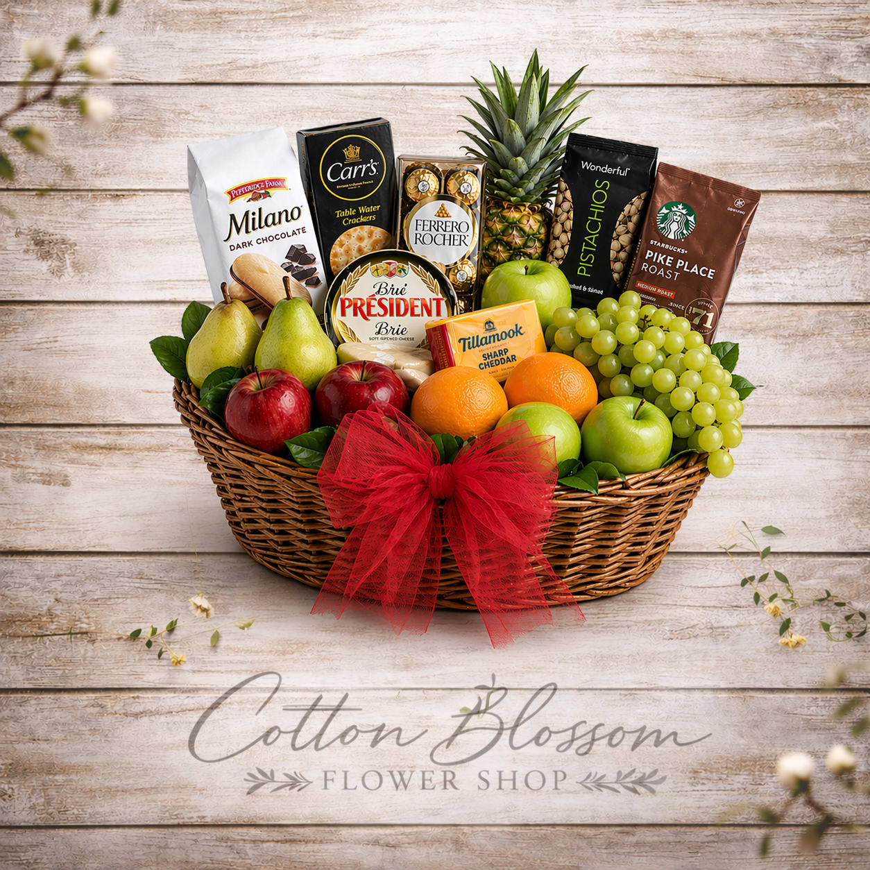 Seasonal Harvest Gourmet Basket - Seasonal Harvest Gourmet Basket  Delight someone special with our Seasonal Harvest Gourmet Basket, a beautifully arranged gift filled with a fresh selection of seasonal fruit, gourmet snacks, cheeses, chocolates, and coffee. Designed in a charming basket with lush greenery and finished with a soft tulle bow, this thoughtful gift offers a lovely balance of sweet, savory, fresh, and indulgent flavors.  Perfect for birthdays, thank-you gifts, get well wishes, sympathy, holidays, or just because, this basket is created to feel abundant, comforting, and special for any occasion.  Because we use fresh seasonal fruit and carefully selected gourmet products, fruit, gourmet items, and baskets may vary based on availability, but your gift will always be created with items of the same value and a similar overall style, quality, and presentation.  Hand-prepared with care by Cotton Blossom Flower Shop, proudly serving Maricopa, Casa Grande, and Stanfield, Arizona.