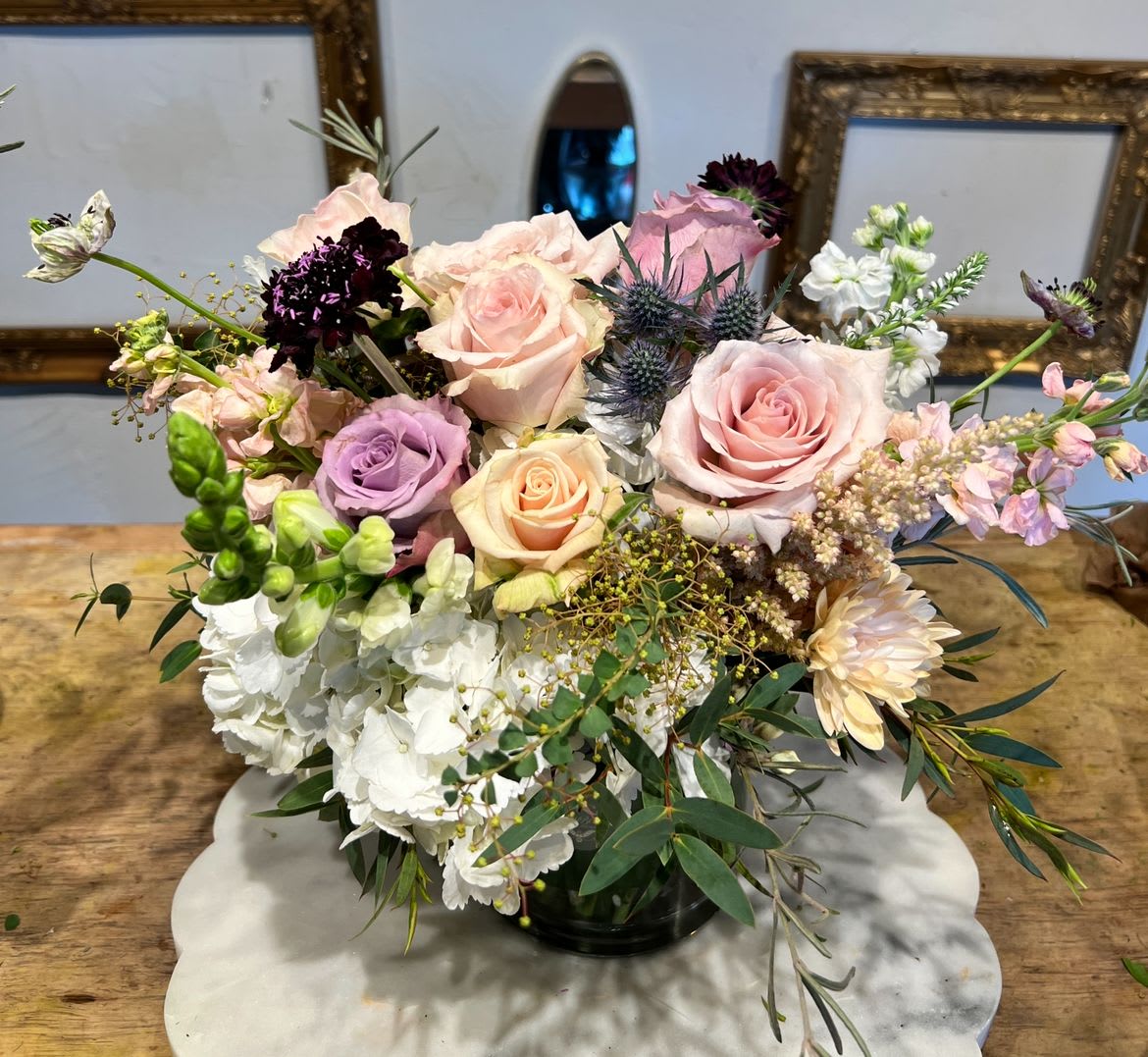 DEEPLY DELICATE - A soft and romantic blend of blush roses, delicate pastels, and lush seasonal blooms, thoughtfully arranged to bring timeless elegance and charm to any setting.