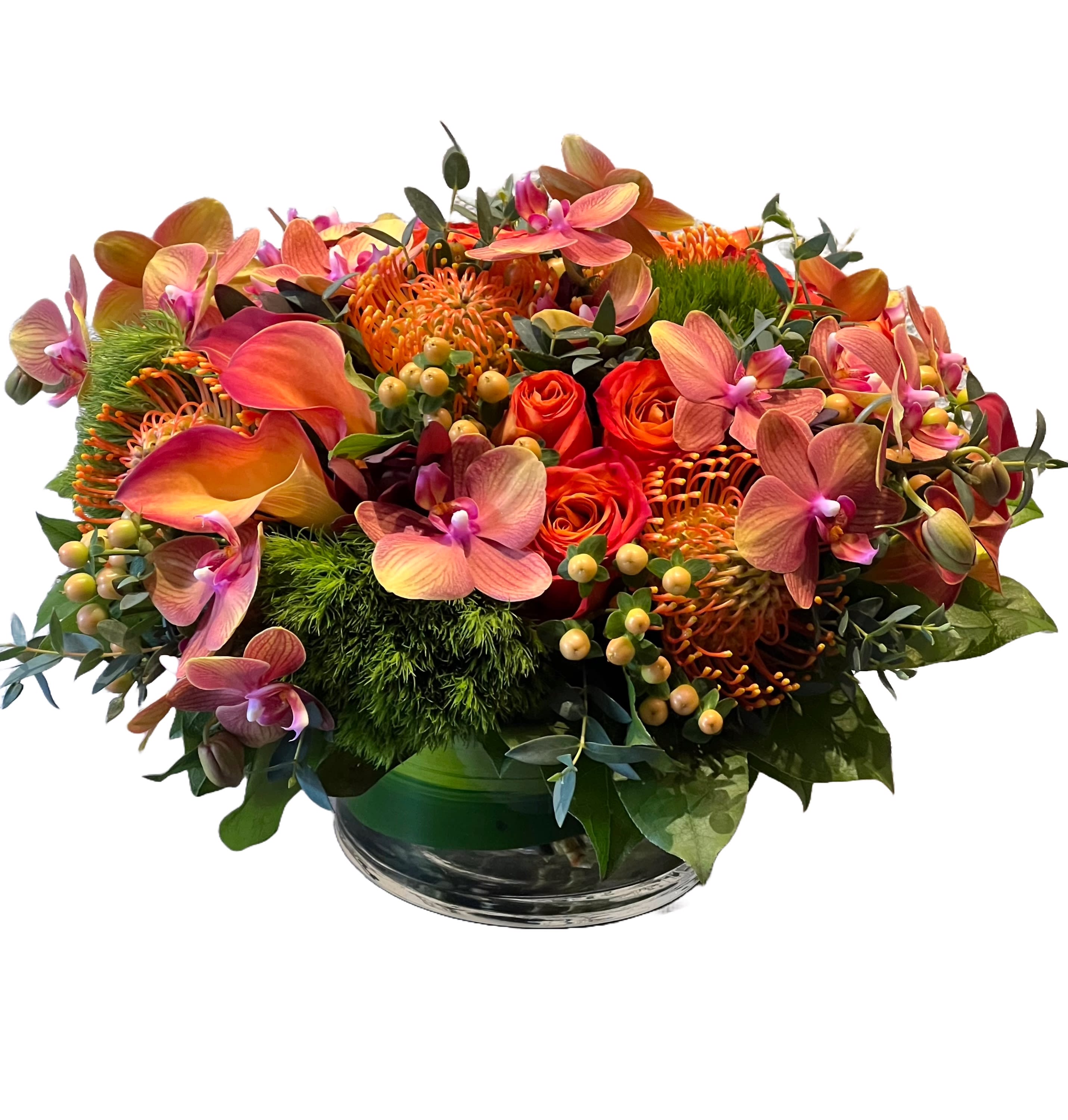 Orange and pink floral arrangement in a glass bowl vase