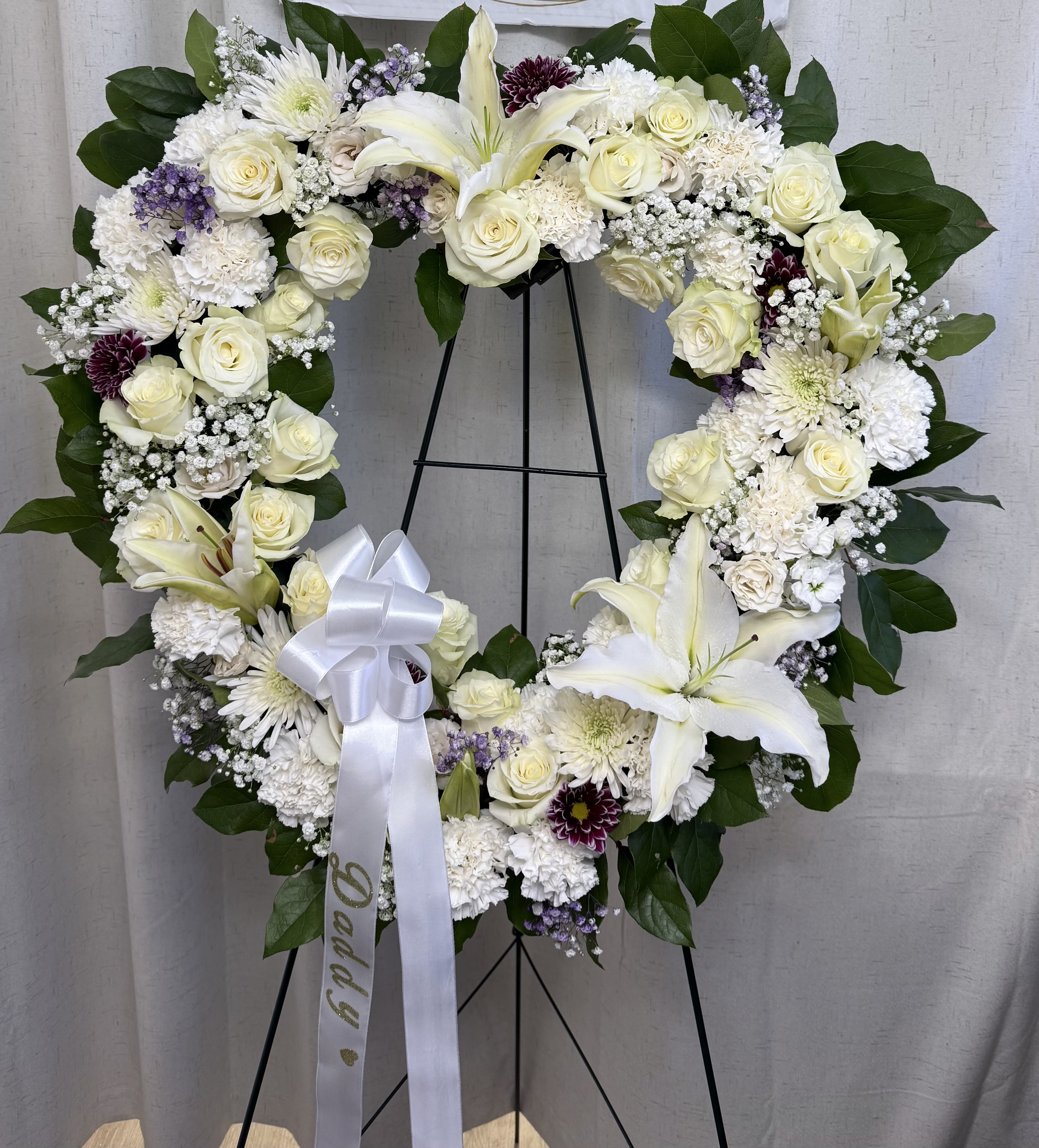 Open Heart Tribute - open heart arrangement, beautifully crafted with flowers in your chosen colors, symbolizing everlasting love and cherished memories. A tender and meaningful tribute that honors a life that will forever remain in our hearts