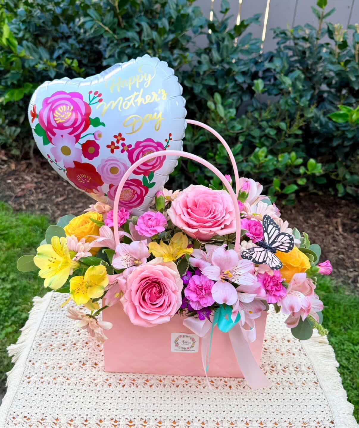 Pink flower basket with a heart-shaped Mother's Day balloon