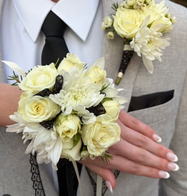 Corsage and boutonniere Set White and Black - Corsage and boutonniere set with White Roses, White cushion pom and Black ribbon. Great for Graduations, Prom and Weddings.