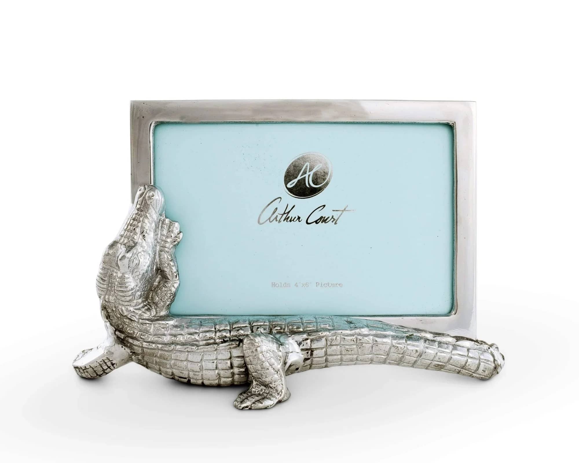 Alligator Picture Frame by Arthur Court (4" x 6") - A playful silver alligator curls protectively around a 4" x 6" picture - the perfect whimsical gift for a coastal cottage, housewarming, or someone who treasures unique tabletop décor. This picture frame works as a casual yet memorable present for birthdays or to commemorate a favorite beach memory; the blue insert and metallic finish give it a light, nautical feel that will make the recipient smile every time they see their photo.  The hard-good construction makes it an easy display piece for mantels, nightstands, or entryway tables.  