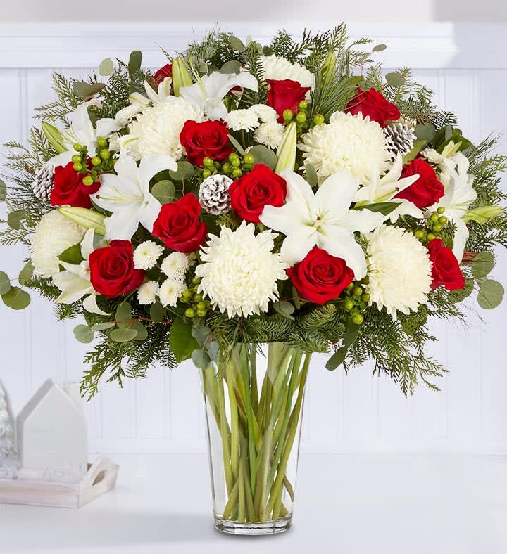Red roses and white lilies in a clear glass vase