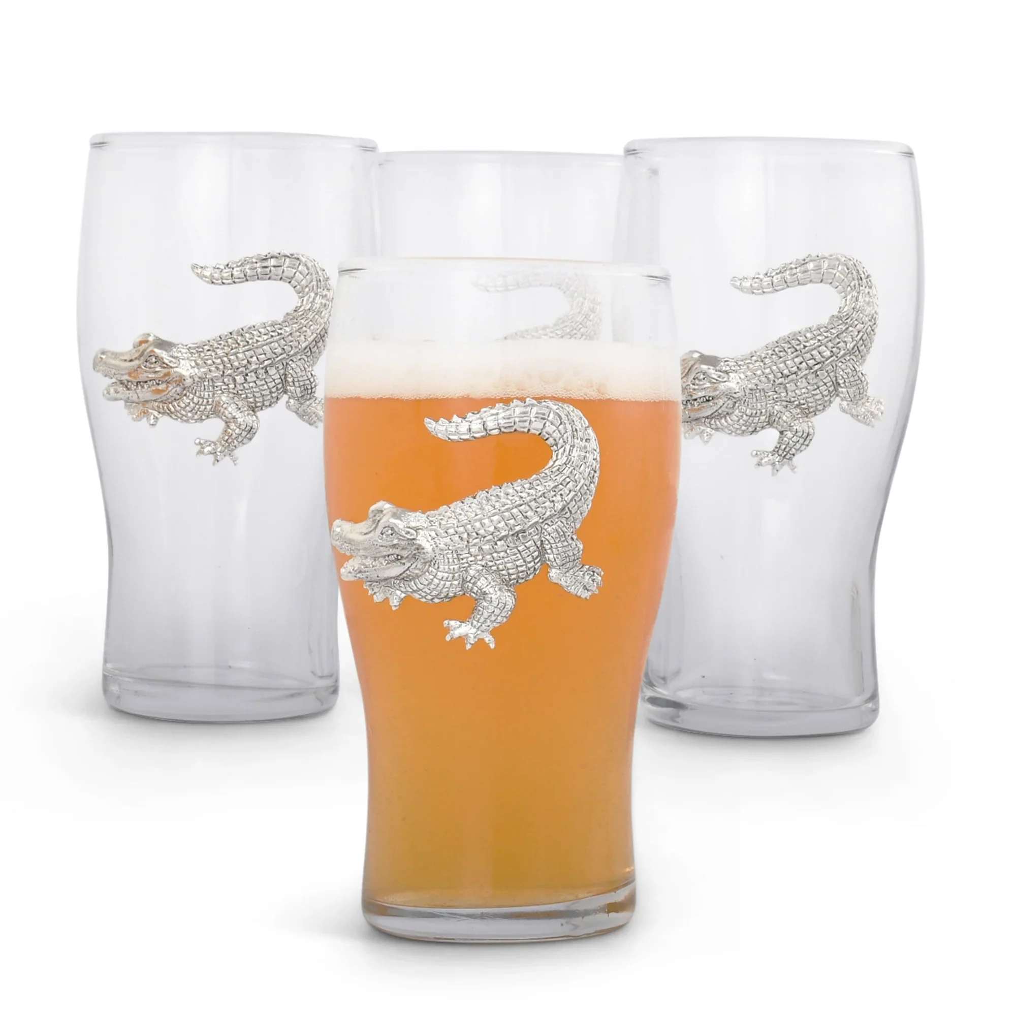 Four clear drinking glasses with silver alligator designs