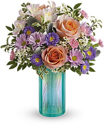 Bouquet of peach roses and purple daisies in a turquoise glass vase