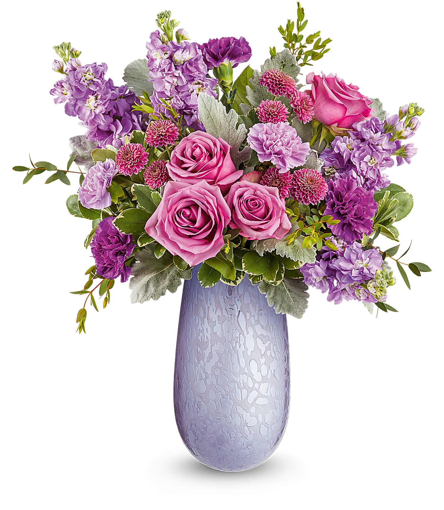 Pink and purple roses, carnations, and mums in a tall lavender patterned glass vase
