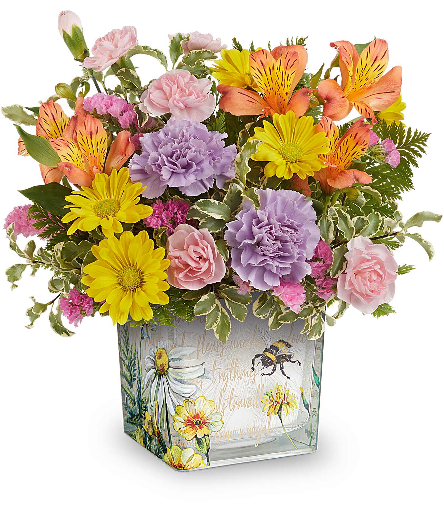 Mixed bouquet in a square glass vase with pink, yellow, orange, and lavender flowers.