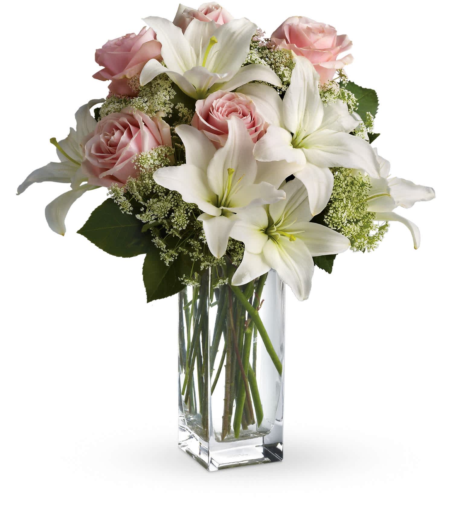 Pink roses and white lilies arranged in a clear glass vase