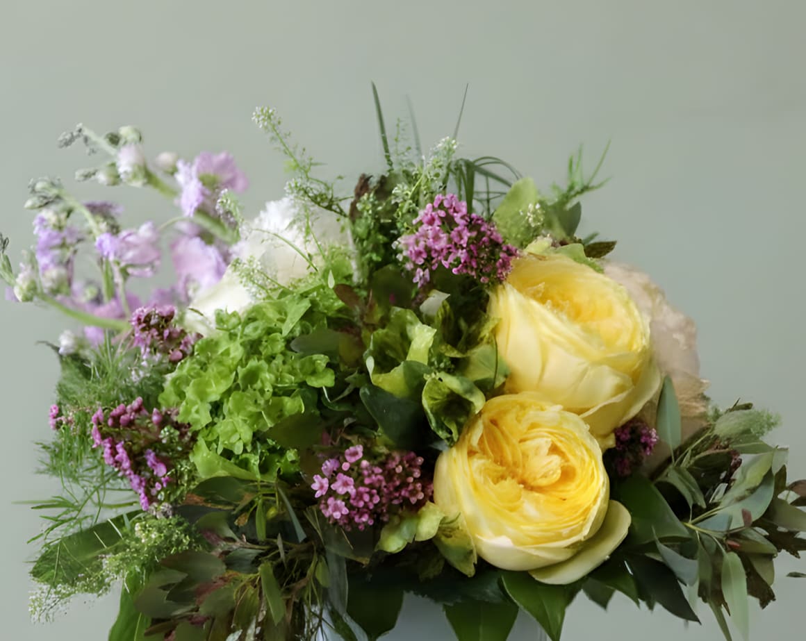 Golden Lights - All the freshly picked premium flowers from a Victorian inspired garden. This arrangement is perfect for Mother's day as one of our exclusive arrangements for Mother's Day featuring garden roses, green hydrangea, penny cress, and lavender stock. 