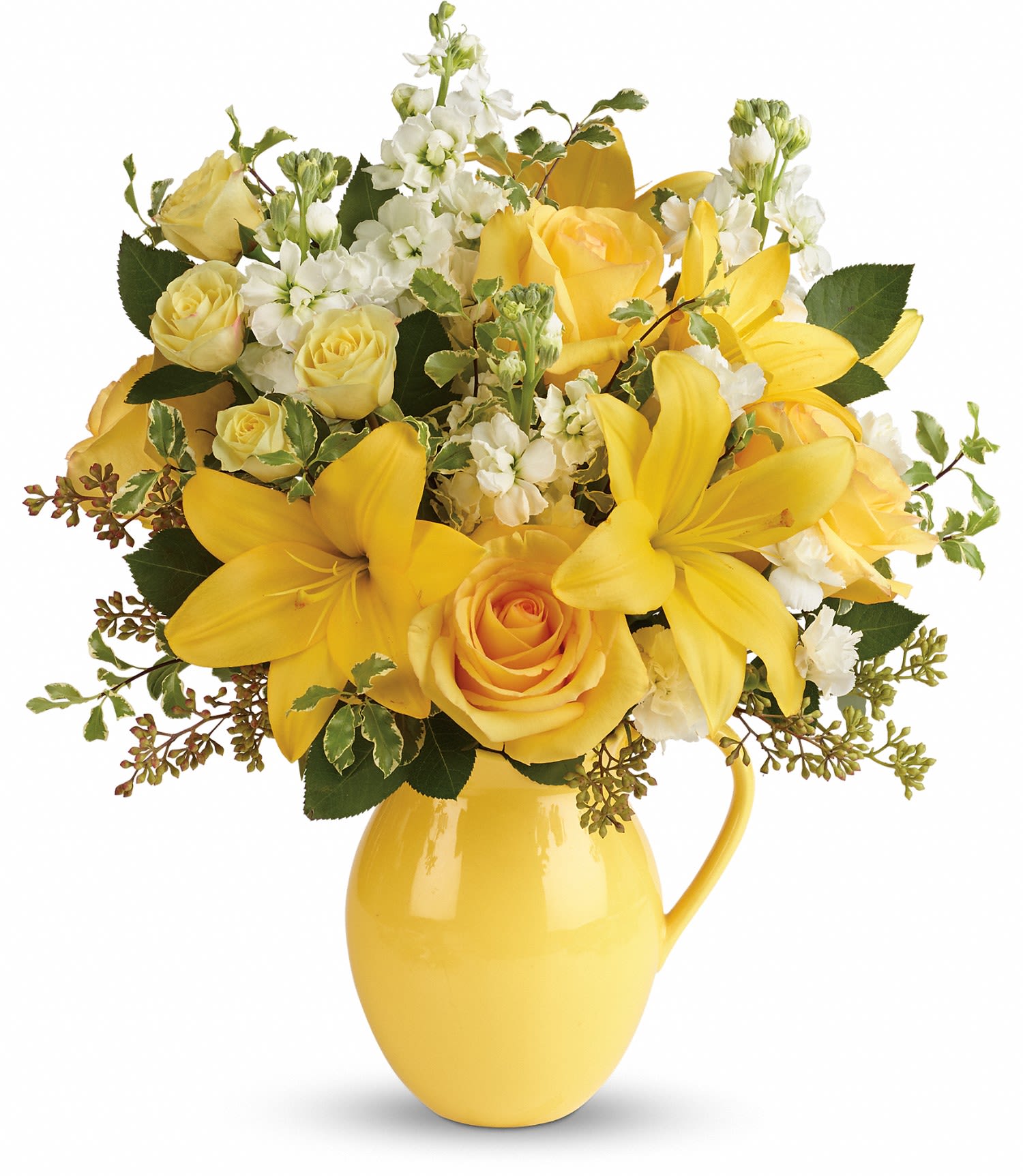 Yellow roses and lilies arranged in a yellow pitcher vase