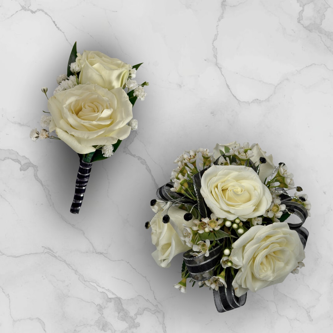 Onyx 4 Rose Combo - Make ordering prom flowers a breeze this year with our Onyx 4 Rose Combo! This combo comes with our Onyx Boutonniere - With Wrap and our Onyx 4 Rose Corsage, perfectly matched together to make a stunning, coordinating look.  The Onyx 4 Rose Corsage has four cream-white roses, nestled among tiny white filler blossoms for soft texture and a fresh, natural look. Black and silver ribbon loops and decorative gem-like rhinestones create an artful, tailored finish, all held together on a white lace wristlet for easy wearing.  The Onyx Boutonniere - With Wrap features two cream-white roses with small white baby's breath filler wrapped in a shimmering black and silver ribbon, with boutonniere pin to hold the piece in place throughout a night of fun and dancing.