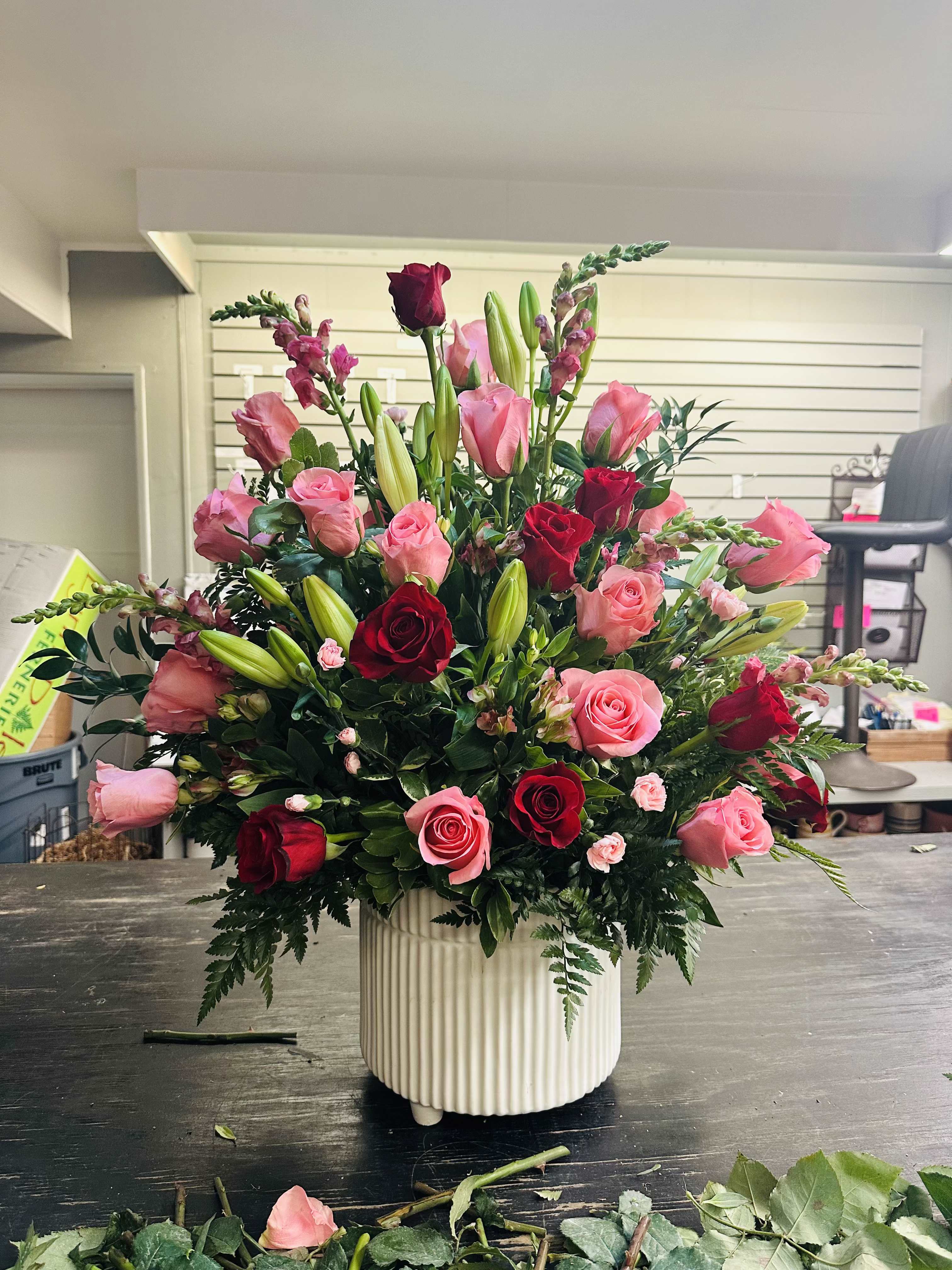 Large bouquet of pink and red roses in a white vase