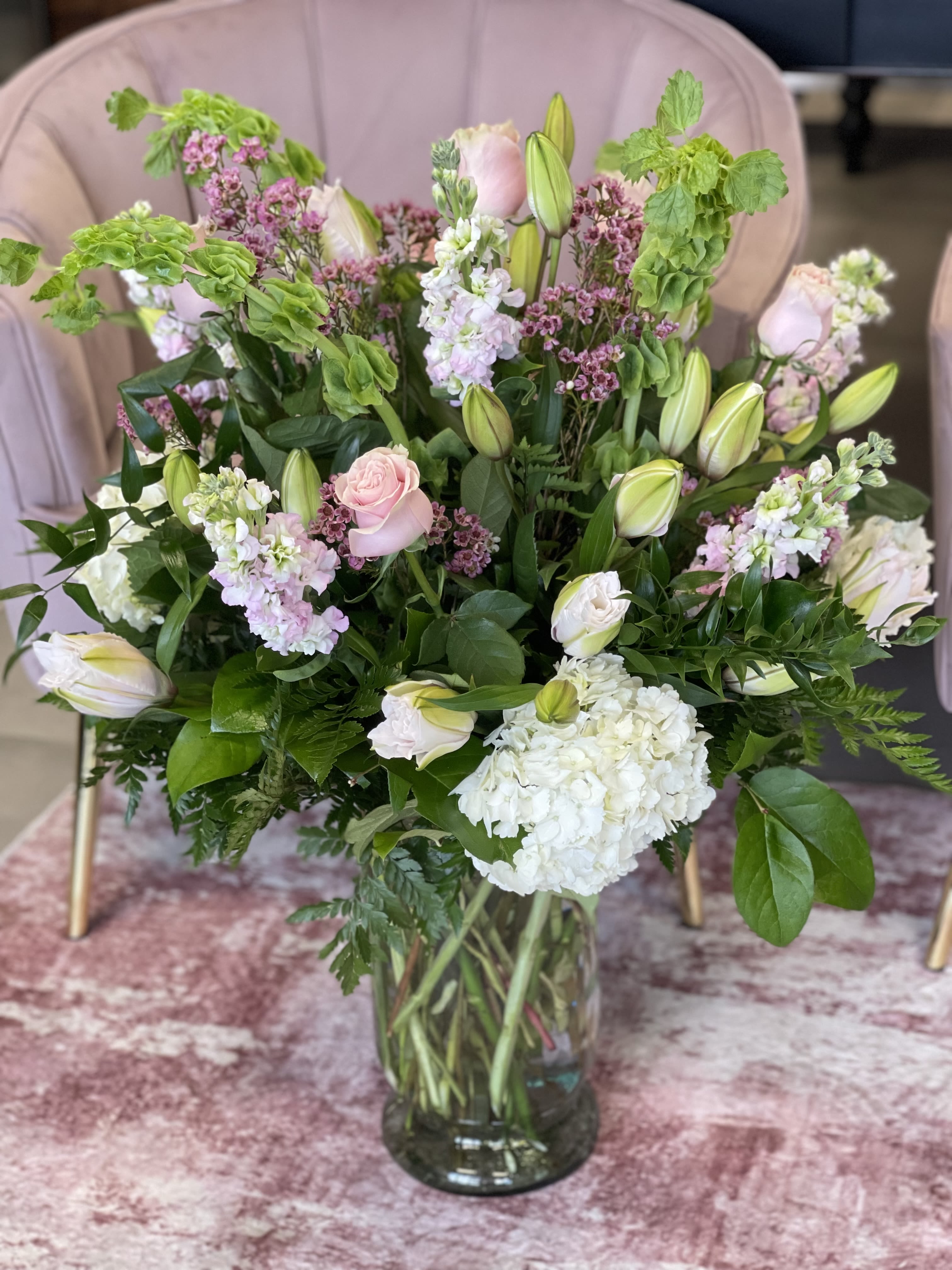 Mixed bouquet of pink and white flowers in a glass vase