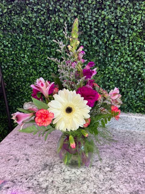 Mixed pink and white flowers in a glass vase