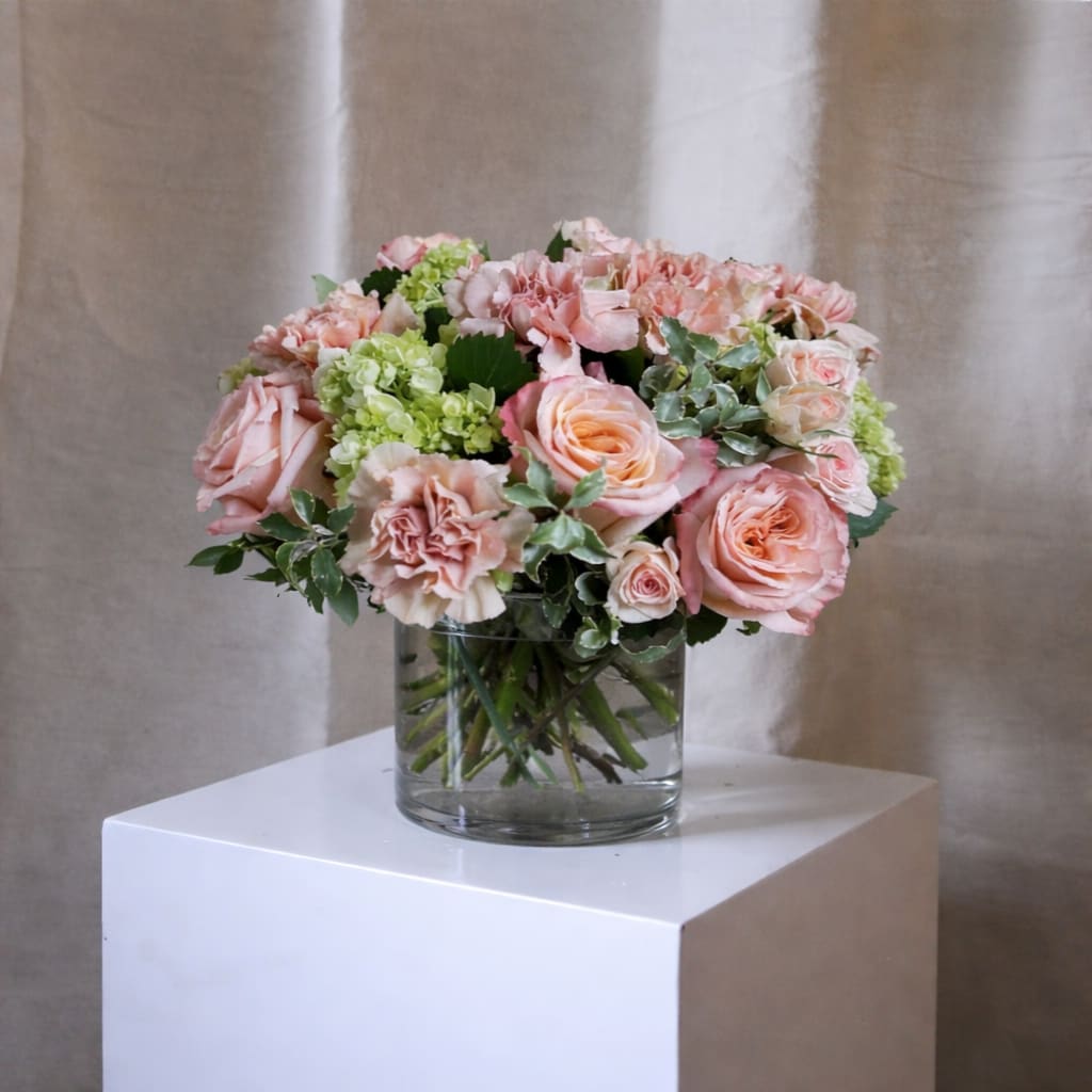 Golden Hour Bouquet - Golden Hour is a low and lush bouquet artfully designed in a clear glass vase using peach &amp; green summer blooms!   *Image shown is valued at $125 *The $150 and $200 price points will be made fuller and more luxurious by adding additional blooms in the same color palette  