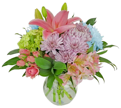 Pink lilies and mixed pastel flowers in a clear glass vase