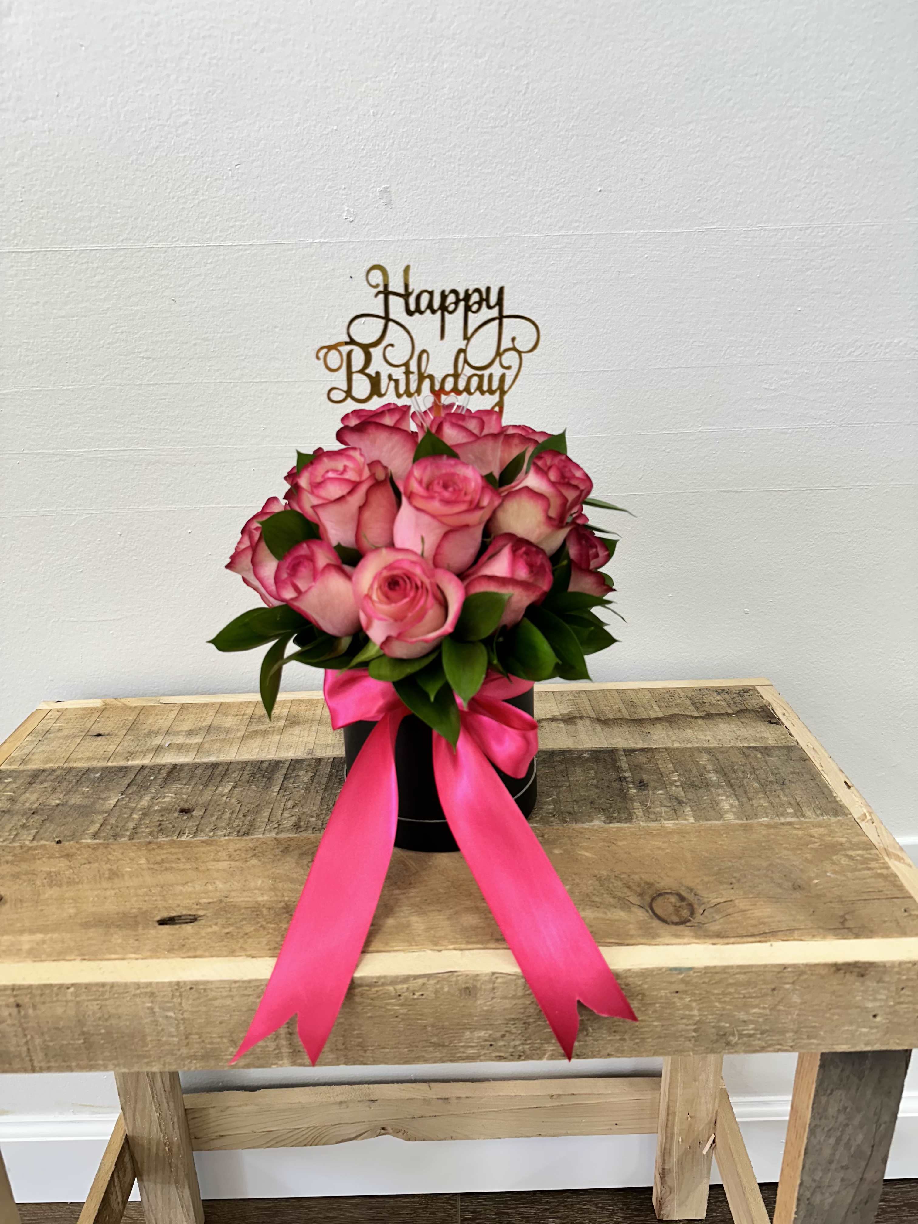 Pink rose bouquet in a black box with a birthday topper and ribbon