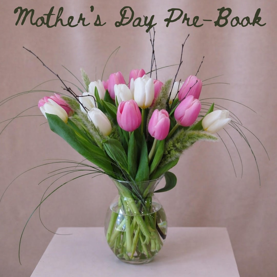 Mom's Gardens - A garden-style arrangement featuring pink and white tulips, bunny tails, and bear grass. Designed in a clear glass vase with visible stems, it has an airy, freshly gathered feel.