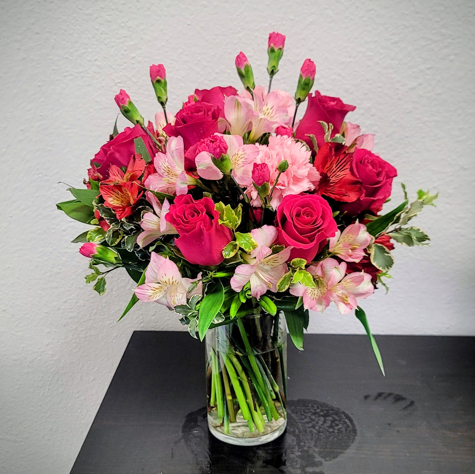Sweet &amp; Pretty Bouquet - This vibrant bouquet features hot pink roses, soft pale pink alstroemeria, and seasonal accent blooms, beautifully arranged in a sleek glass cylinder vase.  The perfect gift to light up someone's day, offering a stunning blend of colors and textures that suit any occasion, whether it’s a birthday, anniversary, or just-because moment.  Approximate Size: 14" H x 14" W. Order now to brighten someone's day with a burst of color! 