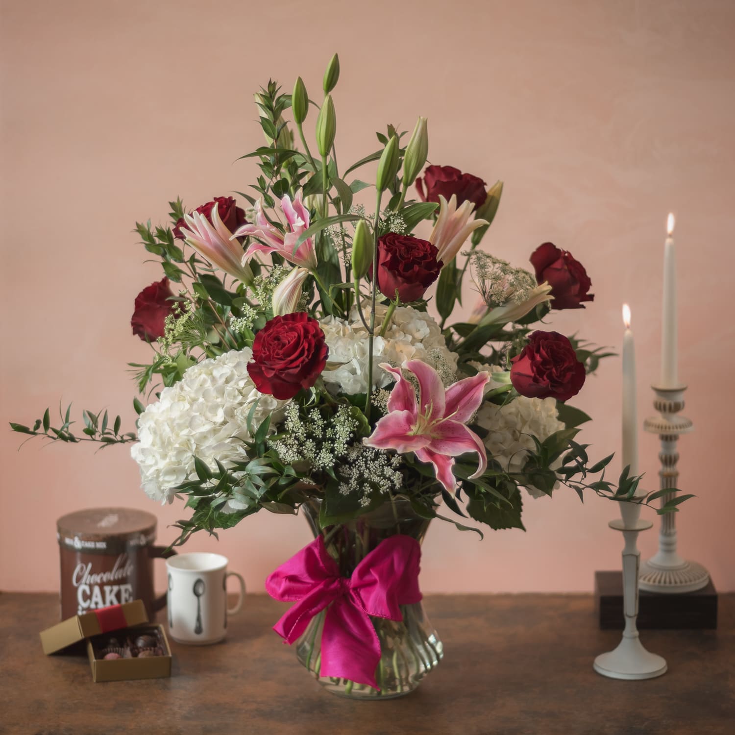 Bountiful Love - White hydrangea, pink oriental lilies and red roses in a shapely glass vase.   Approximately 24 H x 18 W