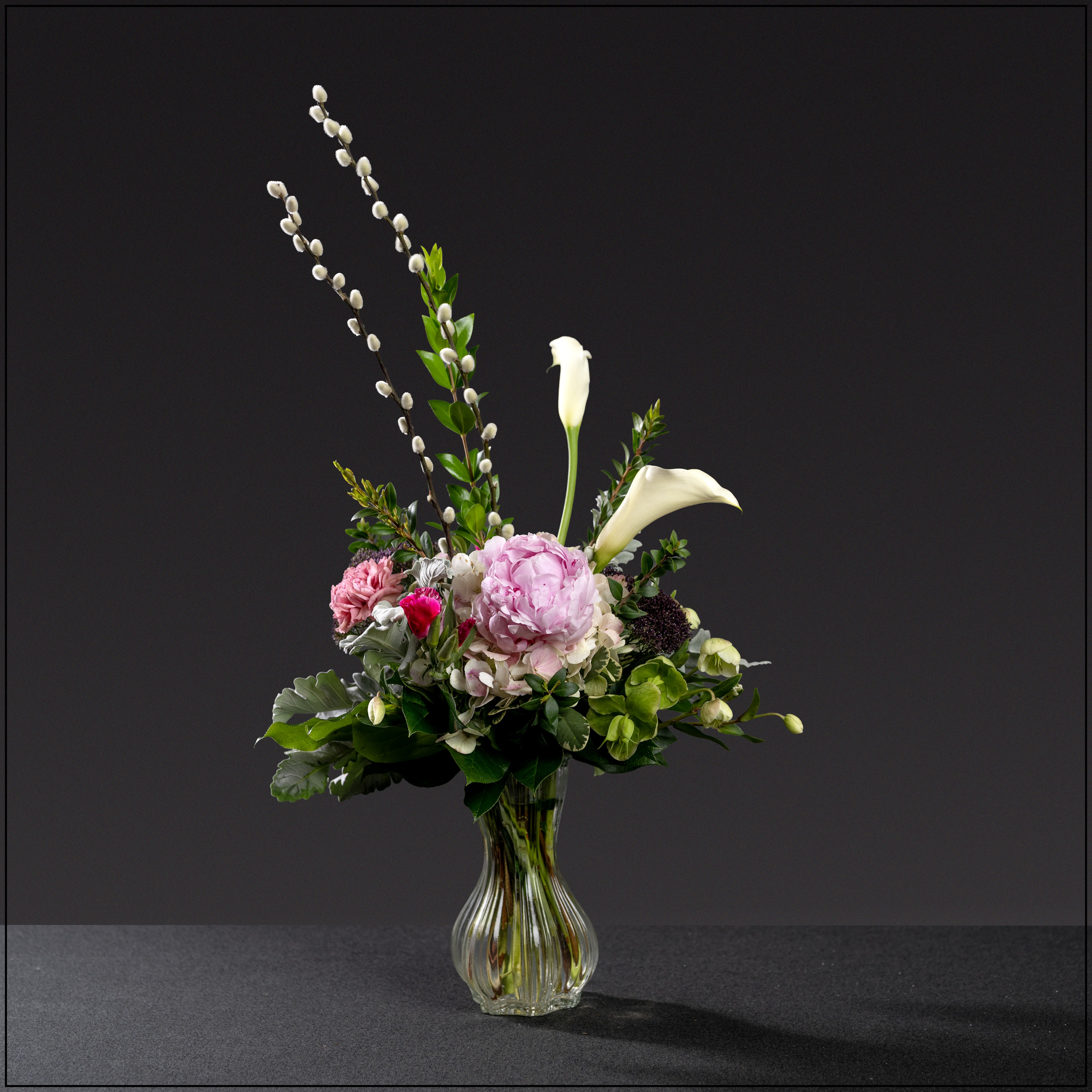 Babe - Elegant cinch vase filled with antique hydrangea, peony, antique carnations, miniature calla lilies, godetia, and helleborus. Approximately 15"x15".